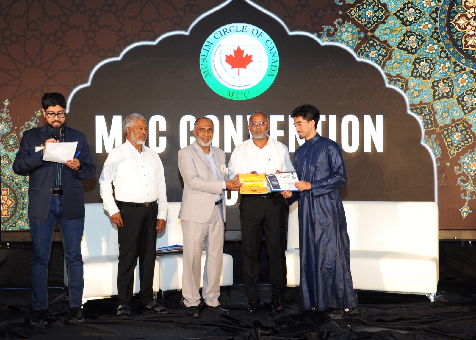 A book award is presented to a NextGen youth