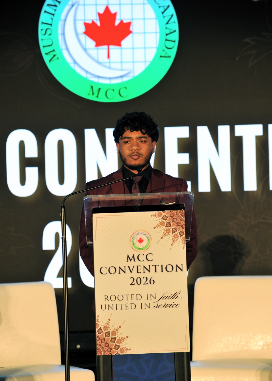 A NextGen youth addresses the MCC Convention 2026 from the podium