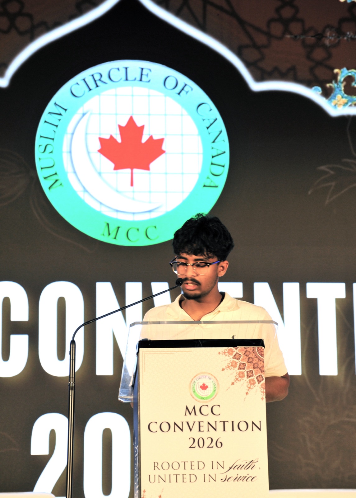 A youth speaker shares his reflections at the podium